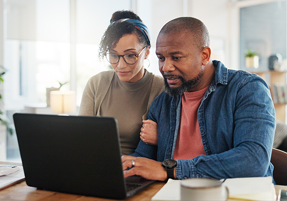 A couple looks over their documents online. 