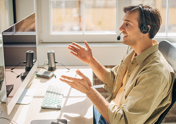 Man at desk looking at computer screen. 