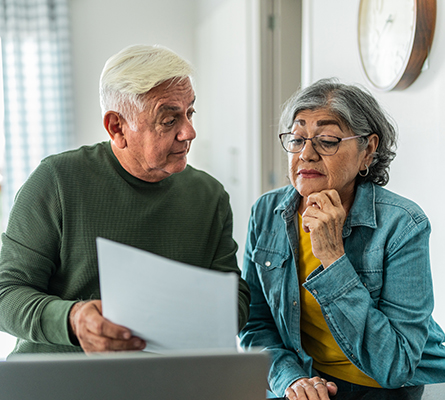 An older couple looking at documents