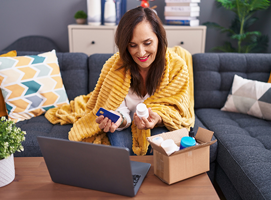 An older woman opening a package that has arrived in the mail
