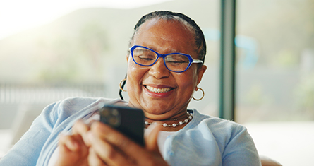A senior woman looks for an in-network pharmacy near her home.