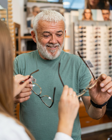 A senior man browses for a new pair of eyeglasses.