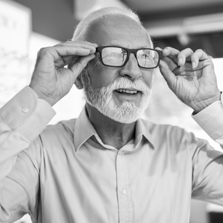 Senior man wearing and adjusting his eyeglasses