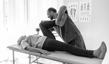 A physical therapist stretched a patient's leg.