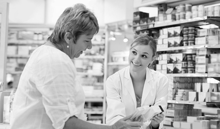Medicare pharmacist helping woman with her prescription. 