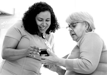 Two members looking at a phone 