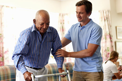 Man helping an elderly man with his balance 