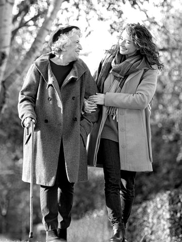 Young woman walking with older woman