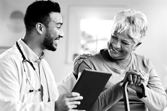 A doctor shows some medical documents to their patient.