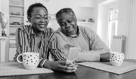 A senior couple navigate a website on their smart phone.