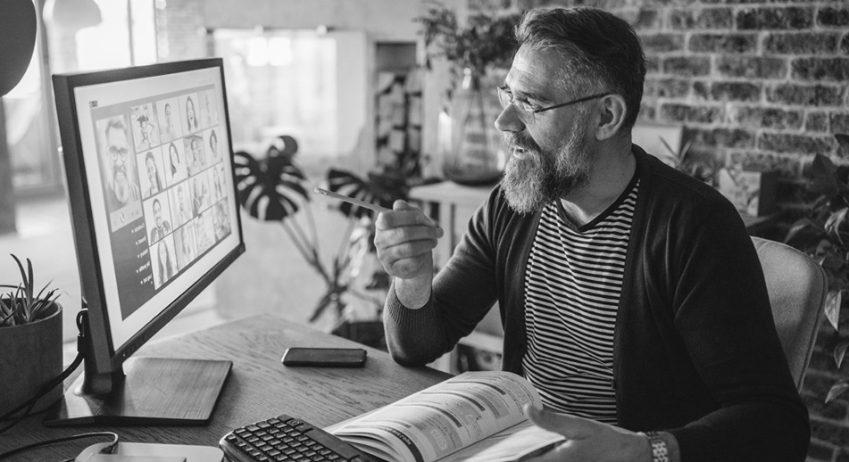 Man at desk looking at computer screen. 