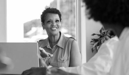 A woman talks to her doctor about a prescription.