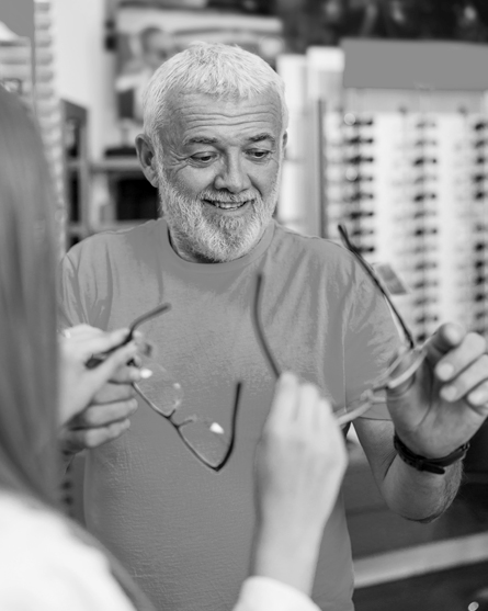 A senior man browses for a new pair of eyeglasses