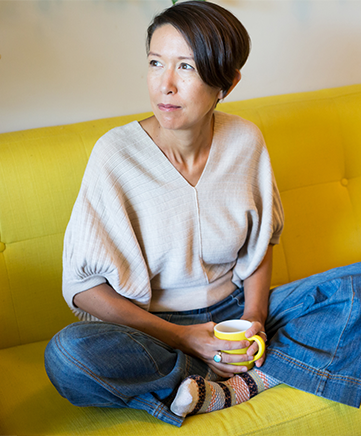 A woman drinks a cup of coffee.