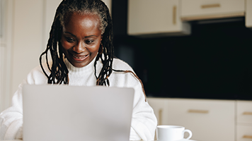 A woman looks at her computer