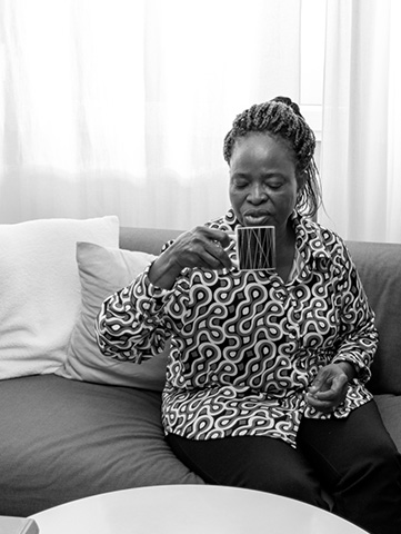 A woman drinks a cup of coffee.