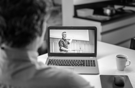 Man watching a presentation on a laptop