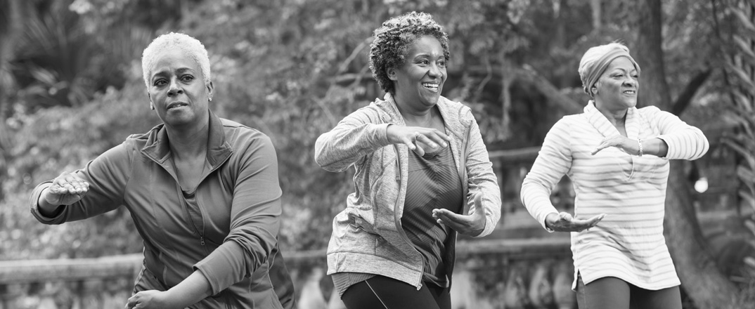 Three women in a tai chi class