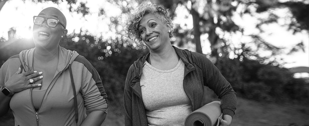 Two women smiling after a yoga class