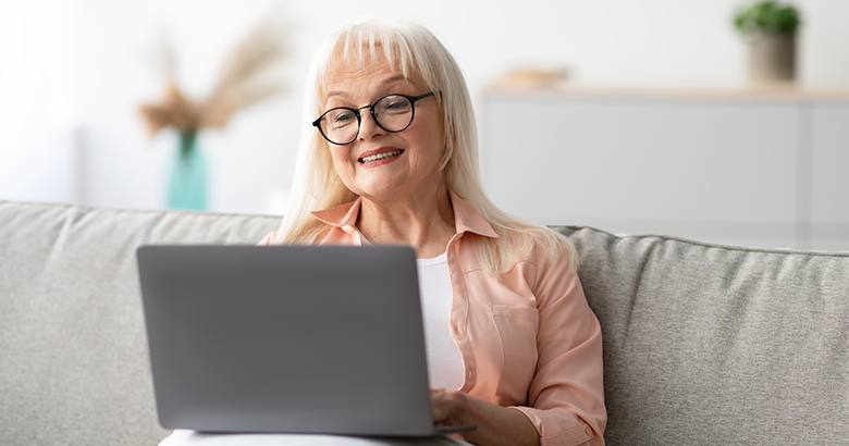  Smiling woman looking at a laptop