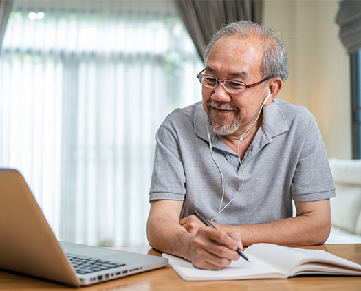 Man watching a presentation on a laptop