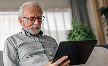 An older man looks at this tablet.