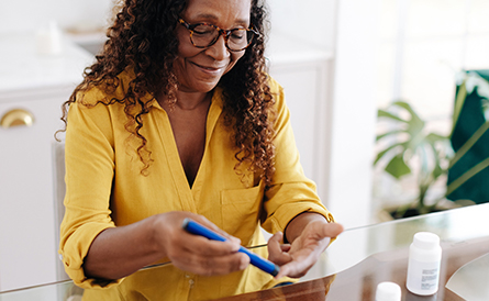 A woman checks her blood sugar.