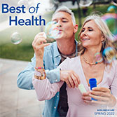 Spring 2022 newsletter cover featuring a man and woman outdoors blowing bubbles.