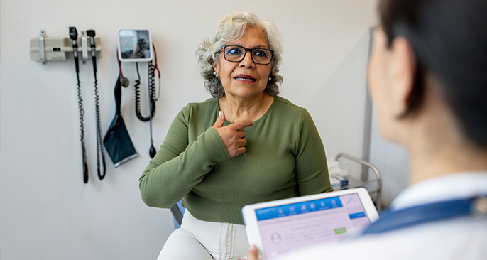 A woman explaining her symptoms to a doctor