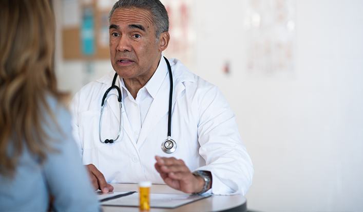 A pharmacist talks to a patient about how to take an opioid medication safely.