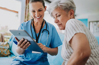 A woman reviews her chart with her doctor.