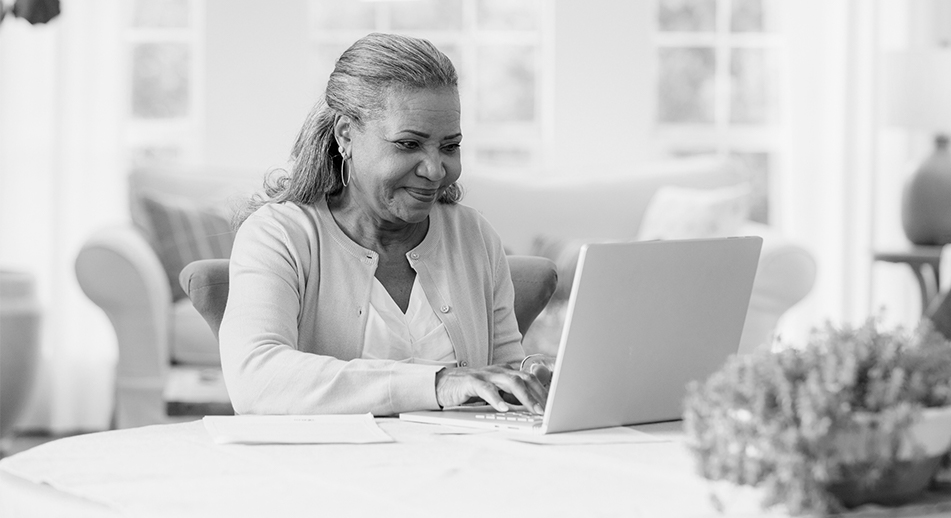 A woman looks up information on her laptop. 