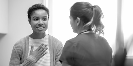 A woman talks to a practitioner about her mental health.