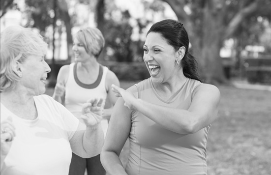 A group of women get excited about working out together.