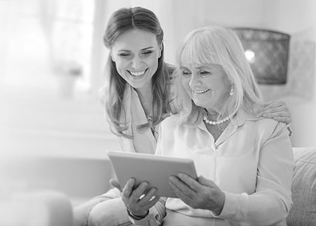 Two women look over their benefits together. 
