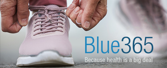 A person ties their running shoe. 