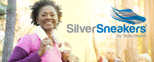 A woman wraps a towel around her neck after exercising. 