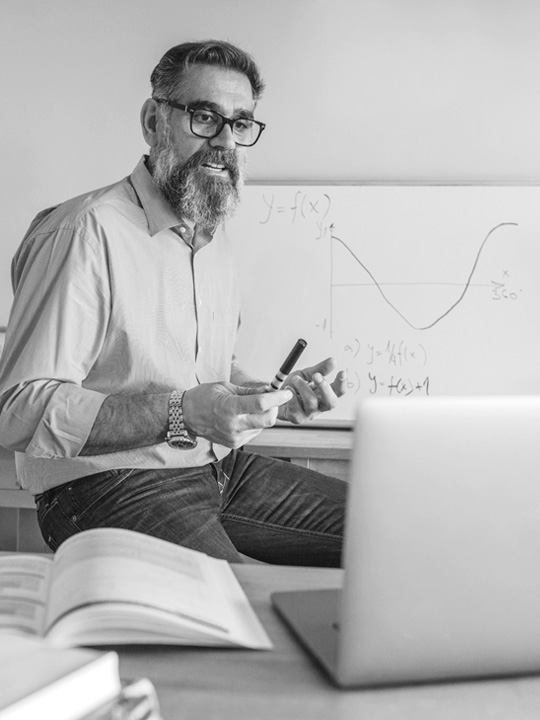Teacher conducts a webinar on his computer.