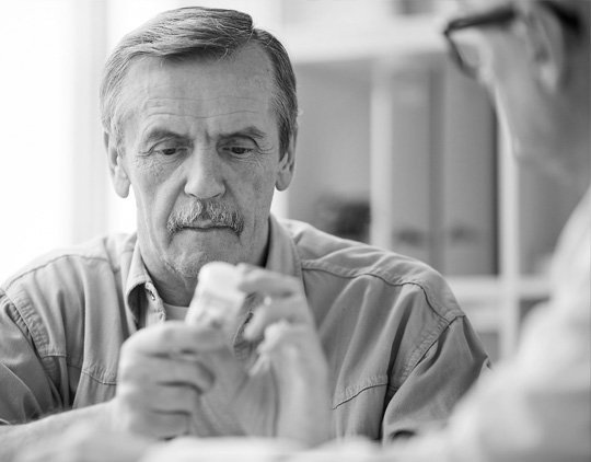 A man reads his prescription label