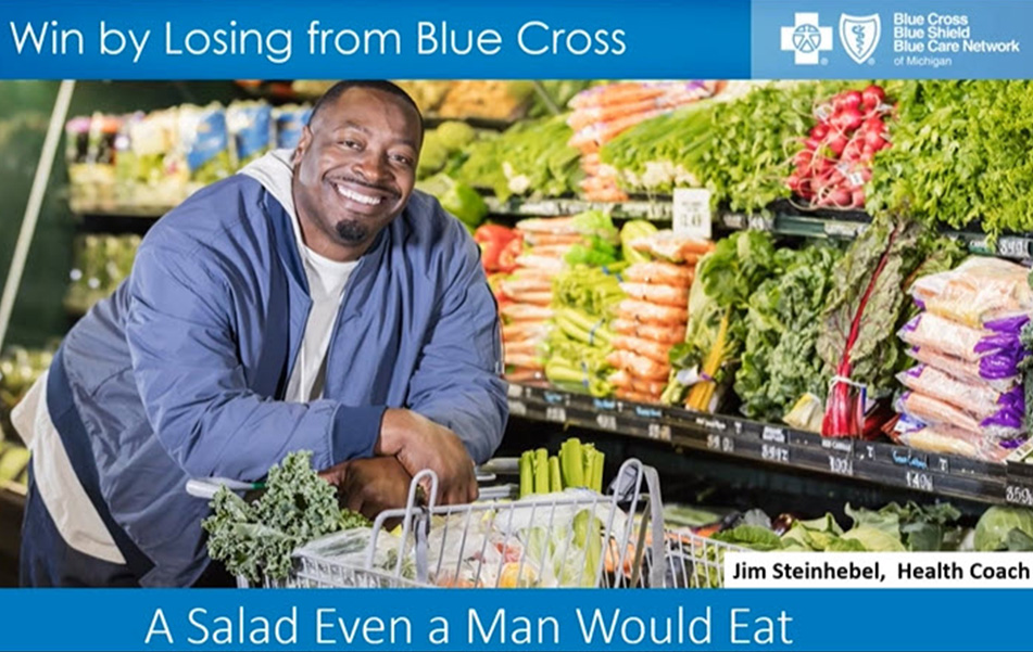 A man smiles in the produce aisle at the grocery store. 