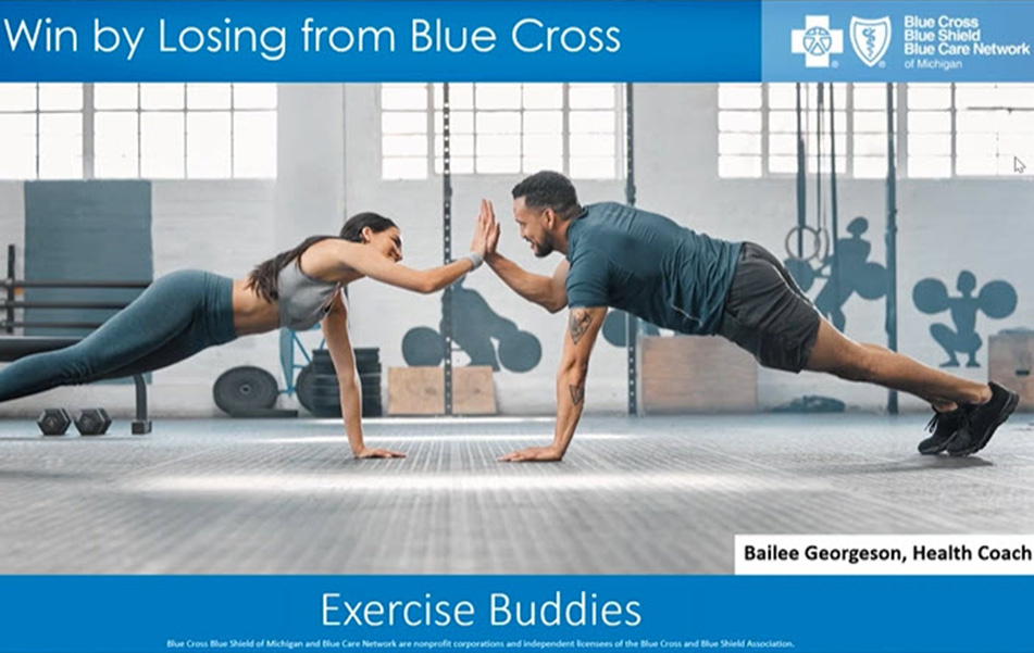 Two exercise partners high five on the gym floor. 
