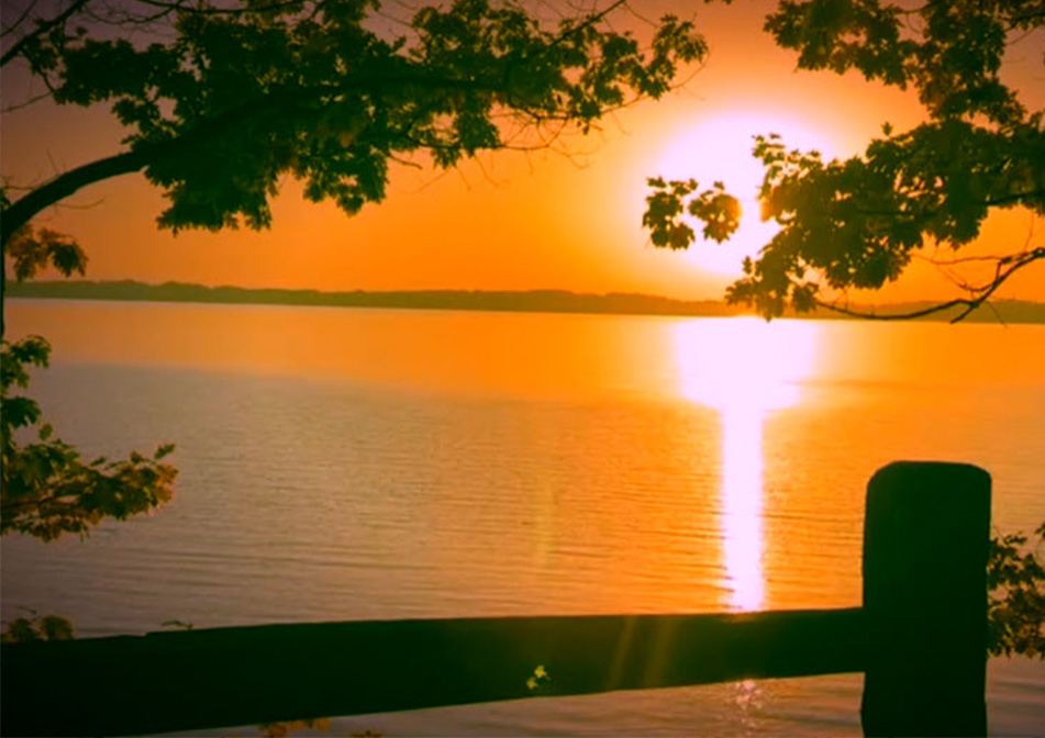 An orange sunset shines over the horizon.