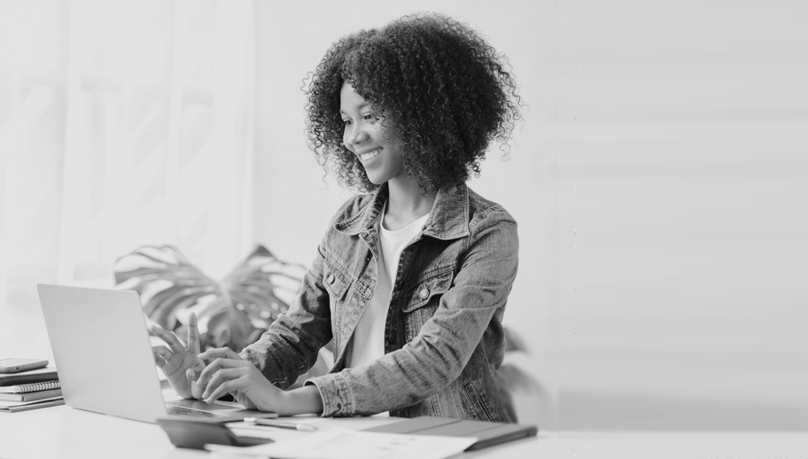 A young woman typing on a laptop