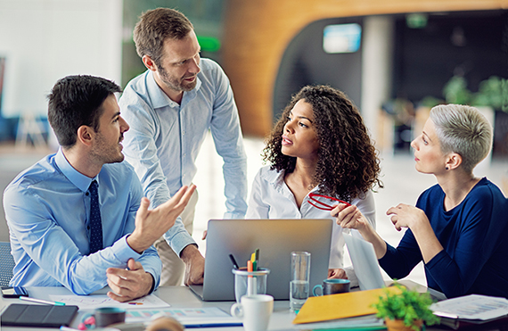 A group of media professionals discuss a project together.