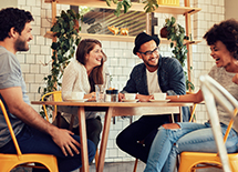 Young adults talk over coffee