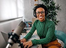 A woman records a podcast
