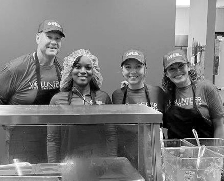 Blue Cross volunteers standing behind a food counter