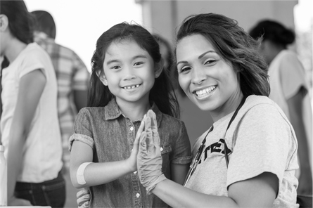 A young girl high fives a woman