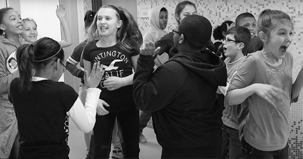 A large group of young kids dancing