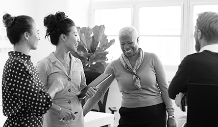 A group of smiling individuals stand together